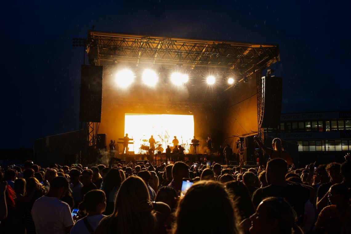 Event stage at night from the POV of visitors